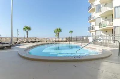 a swimming pool in front of a apartment building at Sunbird 1205W 'Compass Rose Penthouse' in Panama City Beach