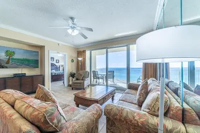 a living room with a couch and a table at Boardwalk 1101 'Parrothead Paradise' in Panama City Beach
