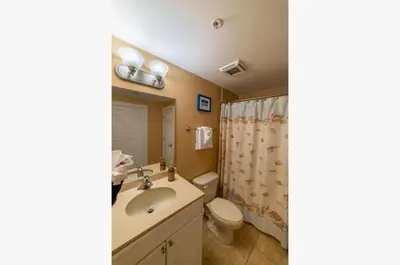 a bathroom with a sink and a toilet at Boardwalk 1111 'Admiral's Quarters' in Panama City Beach