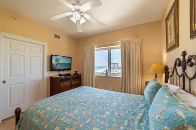 a bedroom with a bed with a view of the ocean at Boardwalk 1111 'Admiral's Quarters' in Panama City Beach