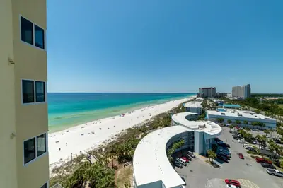 a view of the beach from the balcony of a building at Boardwalk 1111 'Admiral's Quarters' in Panama City Beach