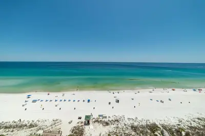a beach with a lot of people and the ocean at Boardwalk 1111 'Admiral's Quarters' in Panama City Beach