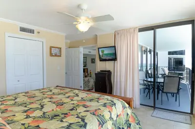 a bedroom with a bed and a dining room at Watercrest 0607 'Sail Away' in Panama City Beach