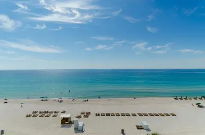 a view of a beach with chairs and the ocean at Watercrest 0607 'Sail Away' in Panama City Beach
