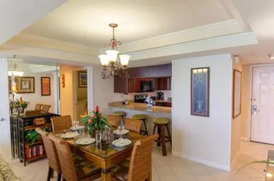 a dining room and kitchen with a table and chairs at Watercrest 0607 'Sail Away' in Panama City Beach