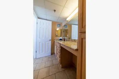 a bathroom with a sink and a mirror at Watercrest 1004 'Neptune's Reef' in Panama City Beach