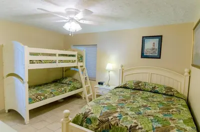 a bedroom with two bunk beds and a ceiling fan at Watercrest 1004 'Neptune's Reef' in Panama City Beach