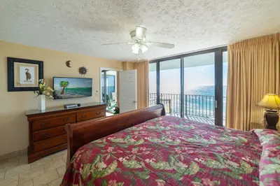 a bedroom with a bed and a view of the ocean at Watercrest 1004 'Neptune's Reef' in Panama City Beach