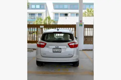 a small white car parked in a parking lot at Watercrest 1004 'Neptune's Reef' in Panama City Beach