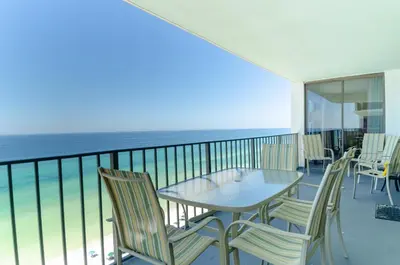 a balcony with a table and chairs and the ocean at Watercrest 1507 'Mermaid's Hideaway' in Panama City Beach