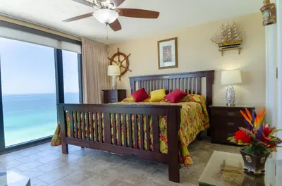 a bedroom with a bed with a view of the ocean at Watercrest 1507 'Mermaid's Hideaway' in Panama City Beach