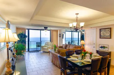 a living room with a table and a couch at Watercrest 1507 'Mermaid's Hideaway' in Panama City Beach