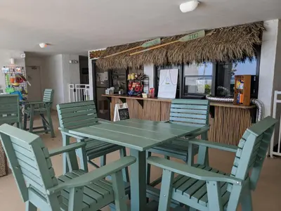 a green table and chairs in a restaurant at Watercrest 1507 'Mermaid's Hideaway' in Panama City Beach