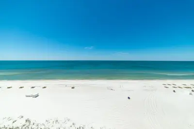 a white beach with the ocean in the background at Edgewater W608 'Sea Forever' in Panama City Beach