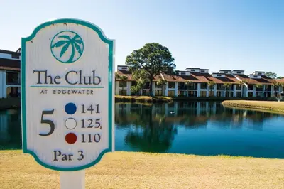 a sign in front of a building with a pool of water at Edgewater W608 'Sea Forever' in Panama City Beach