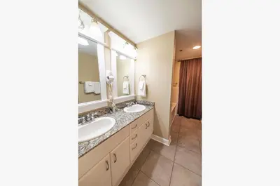 a bathroom with two sinks and a large mirror at Grand Panama 1-1803 'Panama Paradise' in Panama City Beach