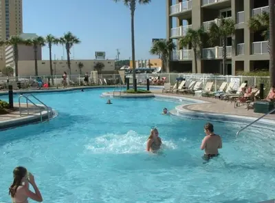 a group of people swimming in a swimming pool at Grand Panama 1-1803 'Panama Paradise' in Panama City Beach