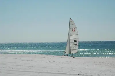 a sail boat on a beach with the ocean at Sunbird 908E 'High Tides' in Panama City Beach