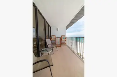 a balcony with chairs and a view of the ocean at Edgewater W607 'Seas The Day' in Panama City Beach