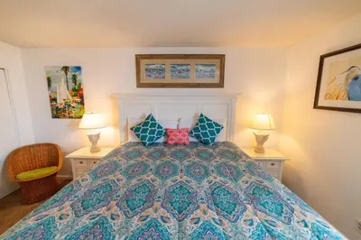 a bedroom with a bed with pillows and two lamps at Edgewater W607 'Seas The Day' in Panama City Beach