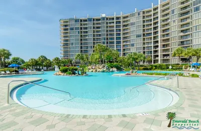 a large swimming pool in front of a large building at Edgewater Villa 907 'Flamingo Sunset' in Panama City Beach