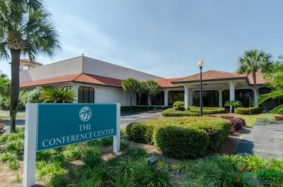 a sign in front of a building at Edgewater Villa 907 'Flamingo Sunset' in Panama City Beach