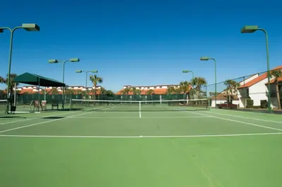 a tennis court with a net on a tennis court at Edgewater 3-0413 'Once Upon A Tide' in Panama City Beach
