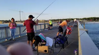 a group of people fishing on a pier at Edgewater 3-0413 'Once Upon A Tide' in Panama City Beach