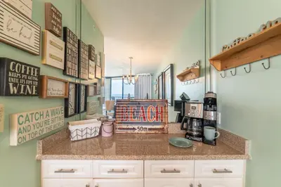 a kitchen with a counter with a counter top at Edgewater 3-0810 'Alpaca My Bags' in Panama City Beach