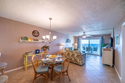 a dining room and living room with a table and chairs at Regency Towers 1122 'Seas The Day' in Panama City