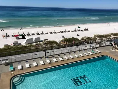 a view of a swimming pool and the beach at Regency Towers 1122 'Seas The Day' in Panama City