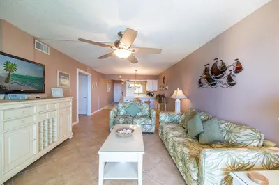 a living room with a couch and a flat screen tv at Regency Towers 1122 'Seas The Day' in Panama City