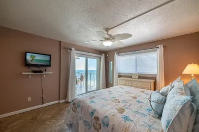 a bedroom with a bed and a tv and a window at Regency Towers 1122 'Seas The Day' in Panama City