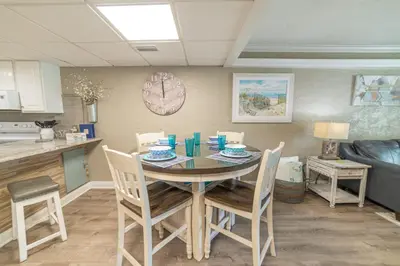 a kitchen and dining room with a table and chairs at Sugar Beach E7 'Ocean Seven' in Panama City Beach