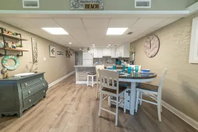 a kitchen with a table and chairs in a room at Sugar Beach E7 'Ocean Seven' in Panama City Beach