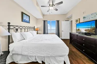 a bedroom with a bed and a flat screen tv at Tidewater 2804 in Panama City Beach