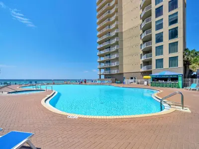 a large swimming pool next to a tall building at Tidewater 2804 in Panama City Beach