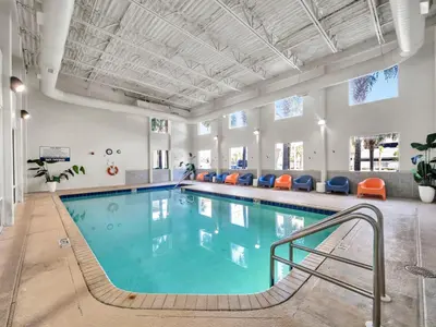 a pool in a large room with a swimming pool at Tidewater 2804 in Panama City Beach