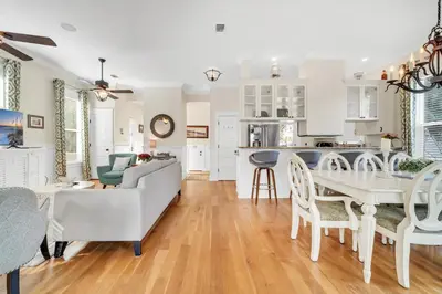 a living room and kitchen with a table and chairs at Daze Gone Bye in Panama City Beach