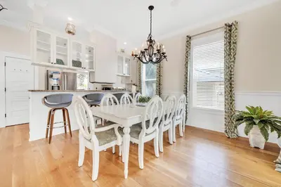 a white dining room with a white table and chairs at Daze Gone Bye in Panama City Beach
