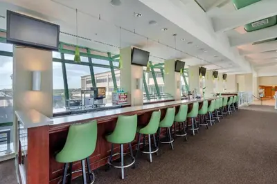 a long bar with green bar stools in a waiting room at Emerald Beach 1535 in Panama City Beach