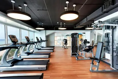 a gym with a row of treadmills and ellipticals at Splash 207E in Panama City Beach