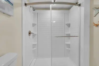 a shower with a glass door in a bathroom at Aquavista 404E in Panama City Beach