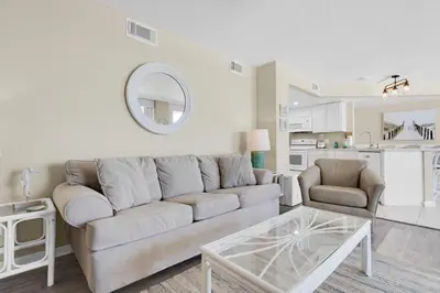 a living room with a couch and a table at Aquavista 404E in Panama City Beach
