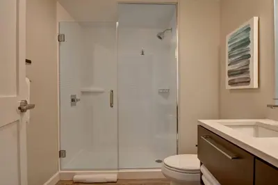 a bathroom with a shower with a toilet and a sink at TownePlace Suites by Marriott Panama City Beach Pier Park in Panama City Beach