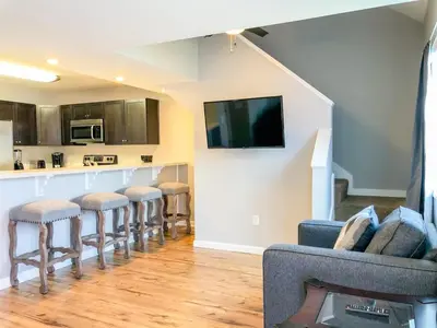 a living room with a bar with stools at 5218 Beach Dr B in Panama City Beach