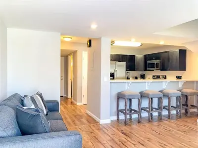 a living room with a couch and a kitchen at 5218 Beach Dr B in Panama City Beach