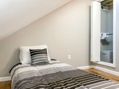 a bed in a room with a white wall at 5218 Beach Dr B in Panama City Beach