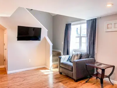 a living room with a chair and a flat screen tv at 5218 Beach Dr B in Panama City Beach