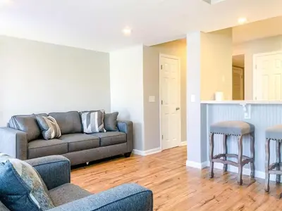 a living room with a couch and two stools at 5218 Beach Dr B in Panama City Beach